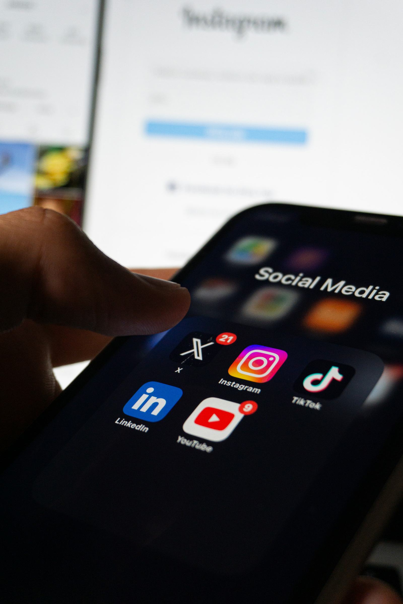 A phone showing social media apps including LinkedIn, Instagram, TikTok and YouTube